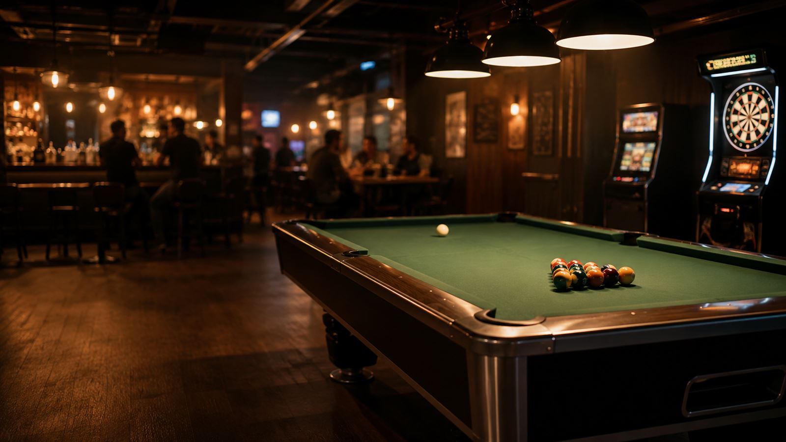 Pool table under warm pendant lights in a bar at night